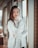 standing woman wearing white crew-neck sweater