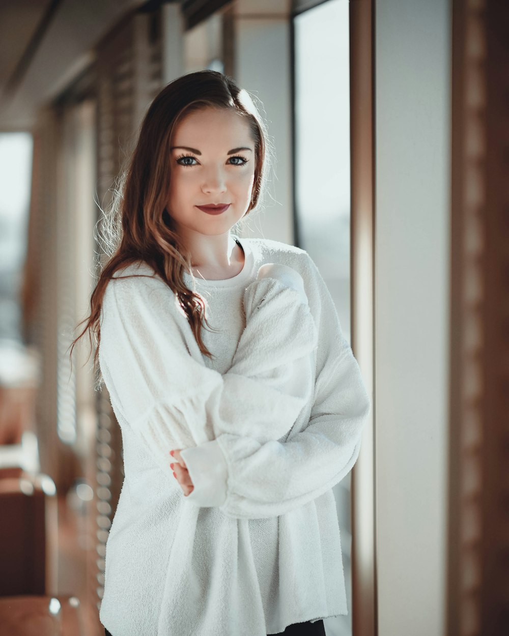 standing woman wearing white crew-neck sweater