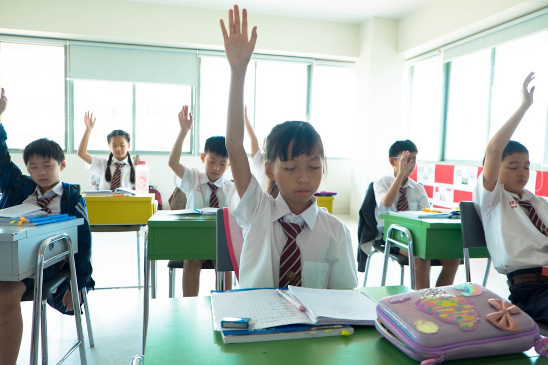 children raising their hands