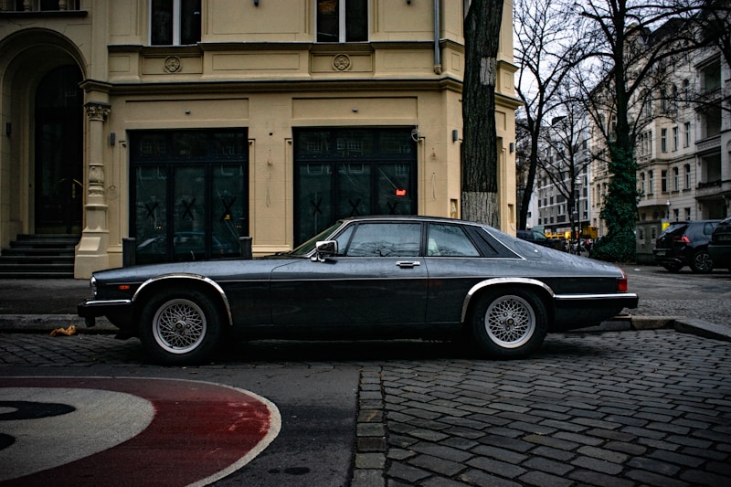 Black coupe near modern architecture