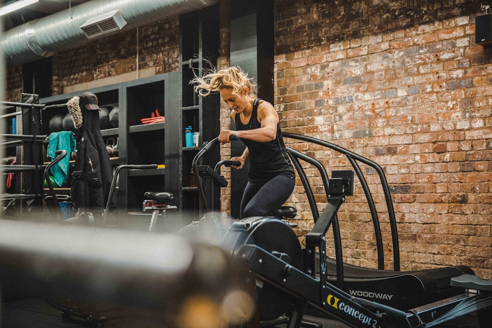 woman using exercise equipment at gym