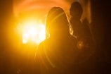 silhouette photography of woman in front of orange light