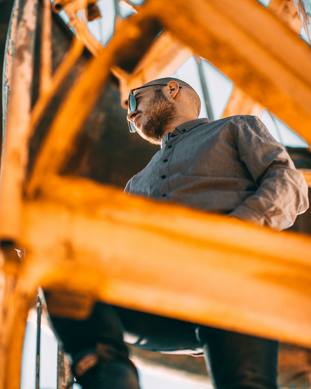 low angle photo of man climbing tower