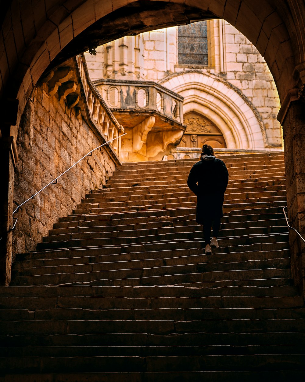 person taking stairs during daytime