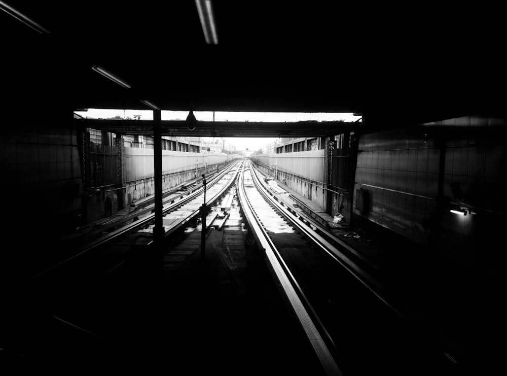grayscale photography of subway track
