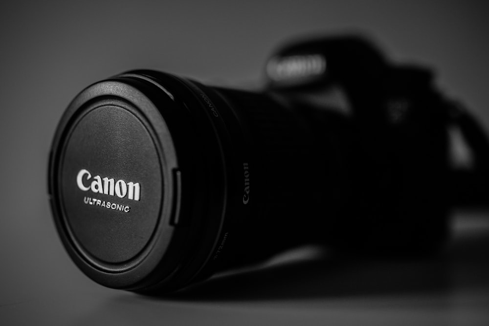 selective focus photography of black Canon Ultrasonic DSLR camera