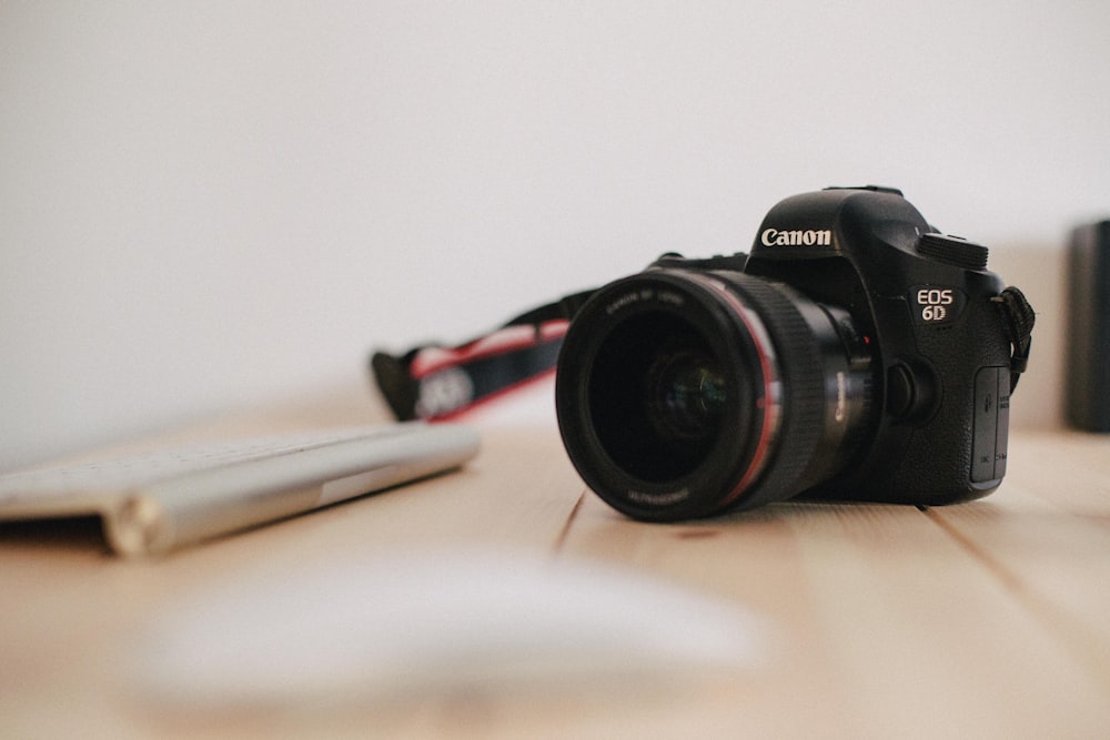 close up photography of black Canon EOS 6D camera on wooden table