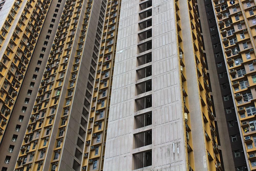 low angle photography of white and yellow multi-storey concrete building