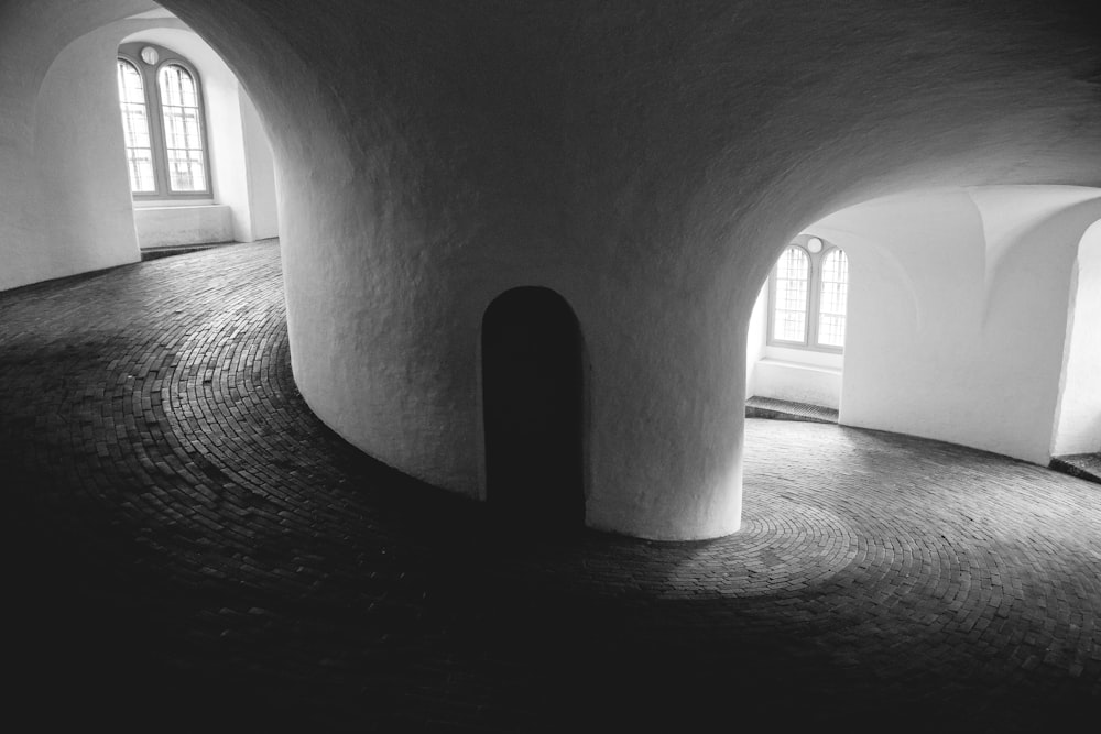 grayscale photo of concrete spiral building