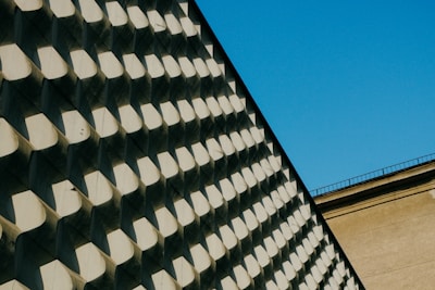 Modern architectural facade with clean lines and deep blue shadows.