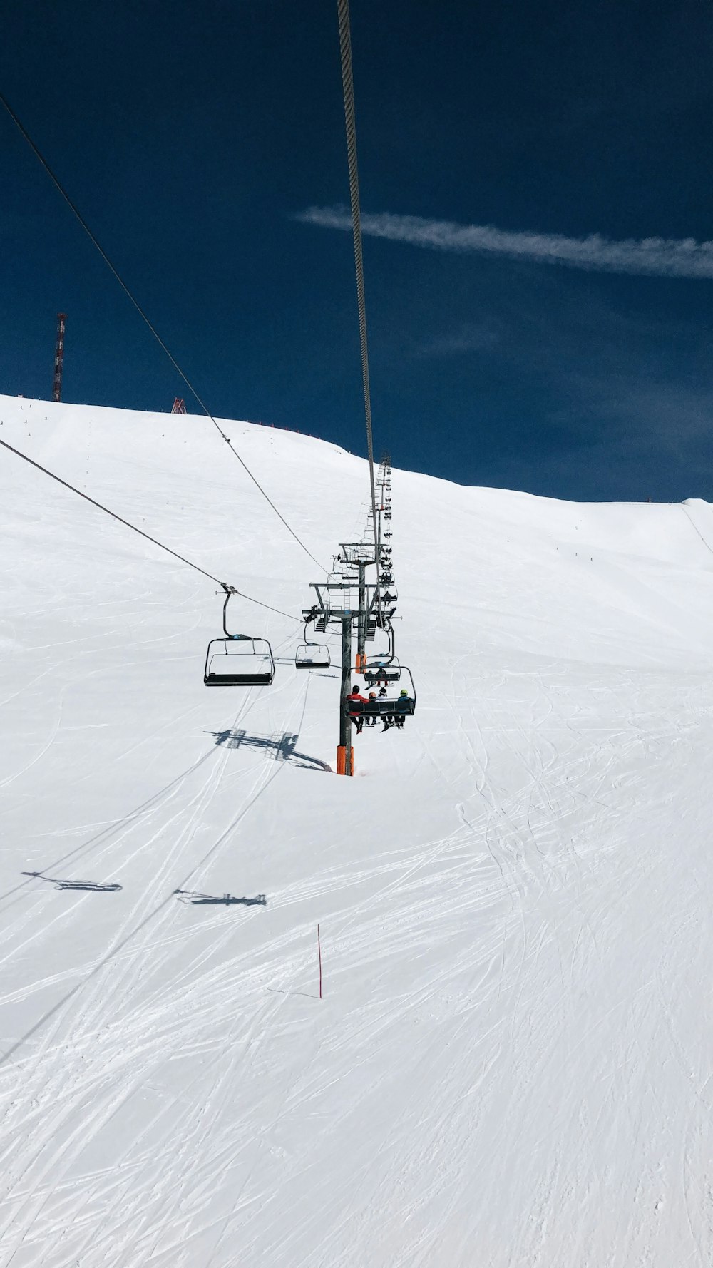 snow cable lifter on snow covered field during daytime