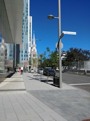 A vibrant street in Saint-Louis showing new urban development with greenery and modern buildings.