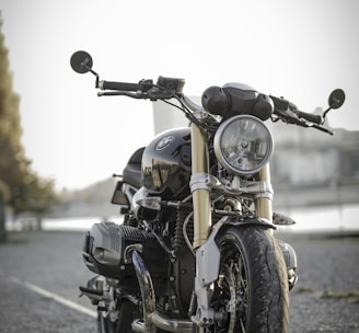 black bobber bike parked on road during daytime