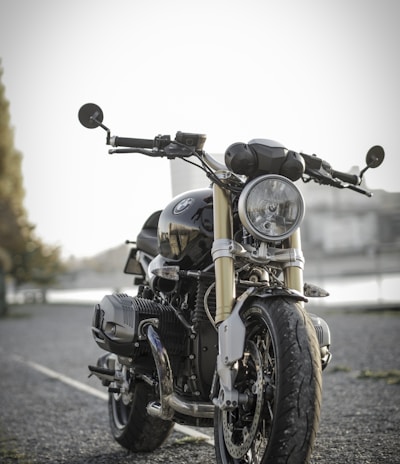 black bobber bike parked on road during daytime