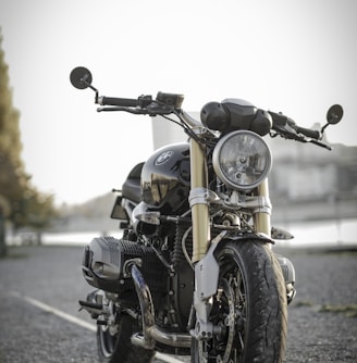 black bobber bike parked on road during daytime