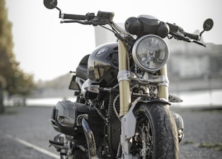 black bobber bike parked on road during daytime