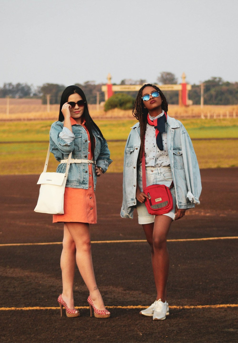 two women standing on sports field during daytime