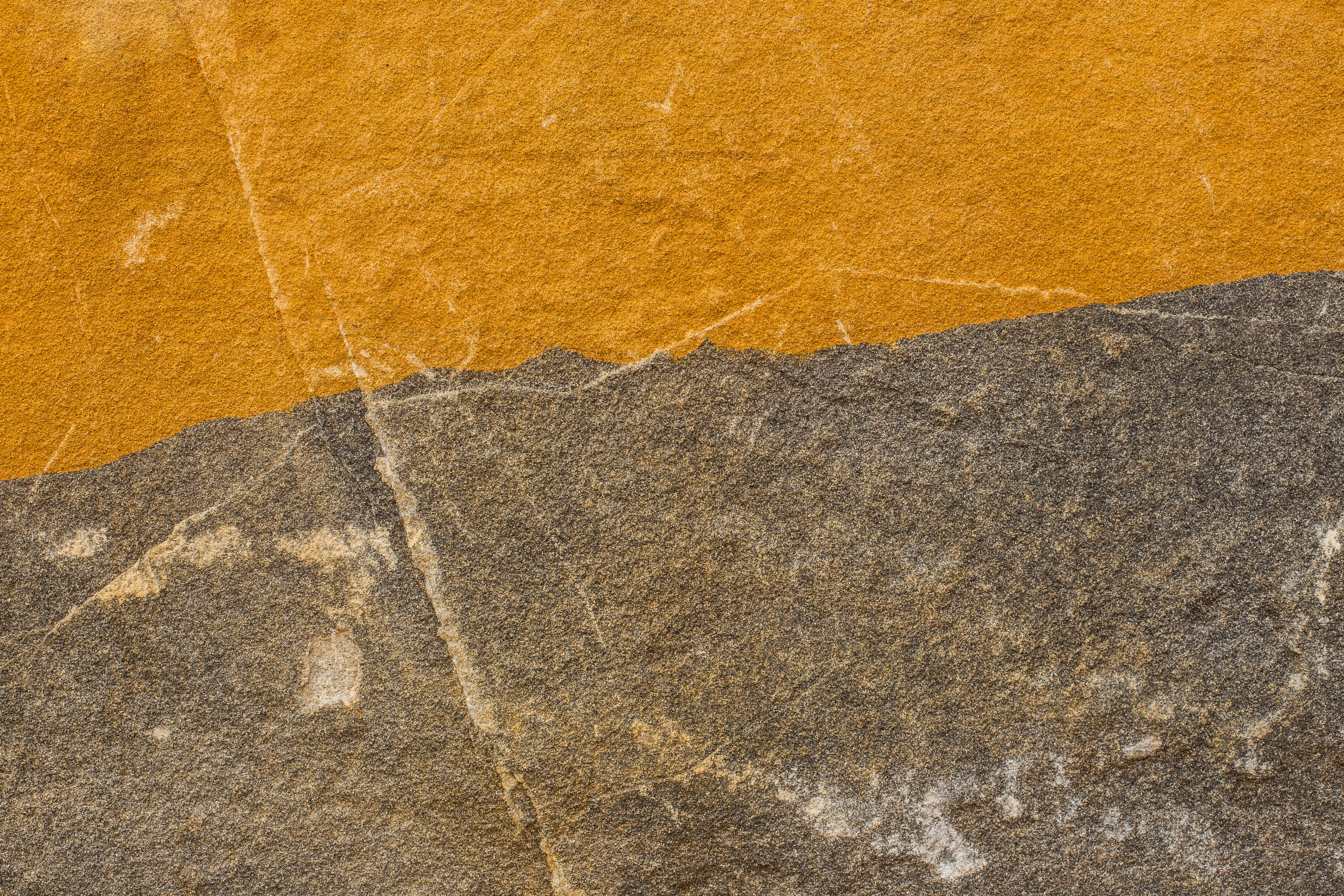 a close up of a yellow and gray wall