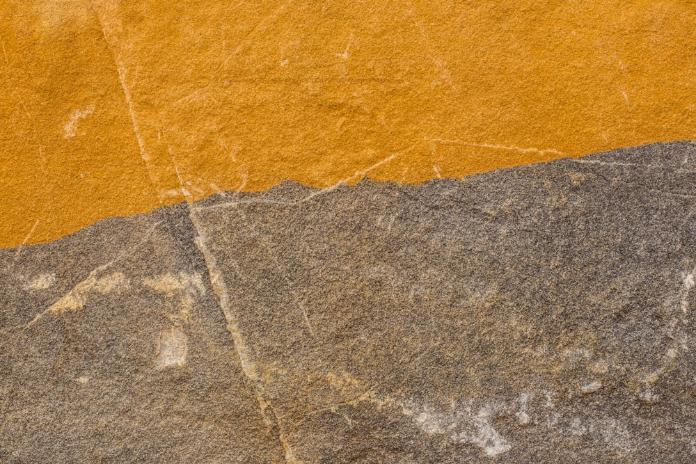a close up of a yellow and gray wall