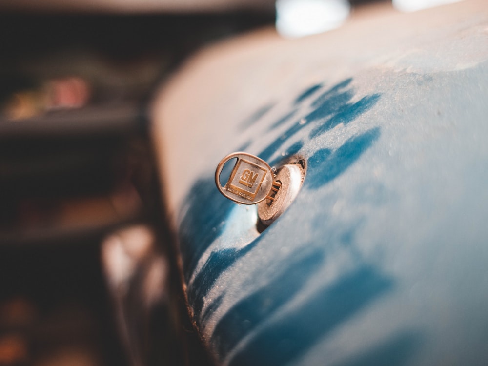 blue GM vehicle key in vehicle keyhole