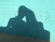 An intimate moment between two characters in the film, framed by the colorful walls of a San Miguel alley.
