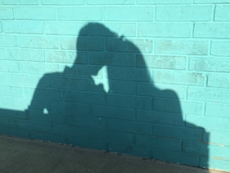 An intimate moment between two characters in the film, framed by the colorful walls of a San Miguel alley.