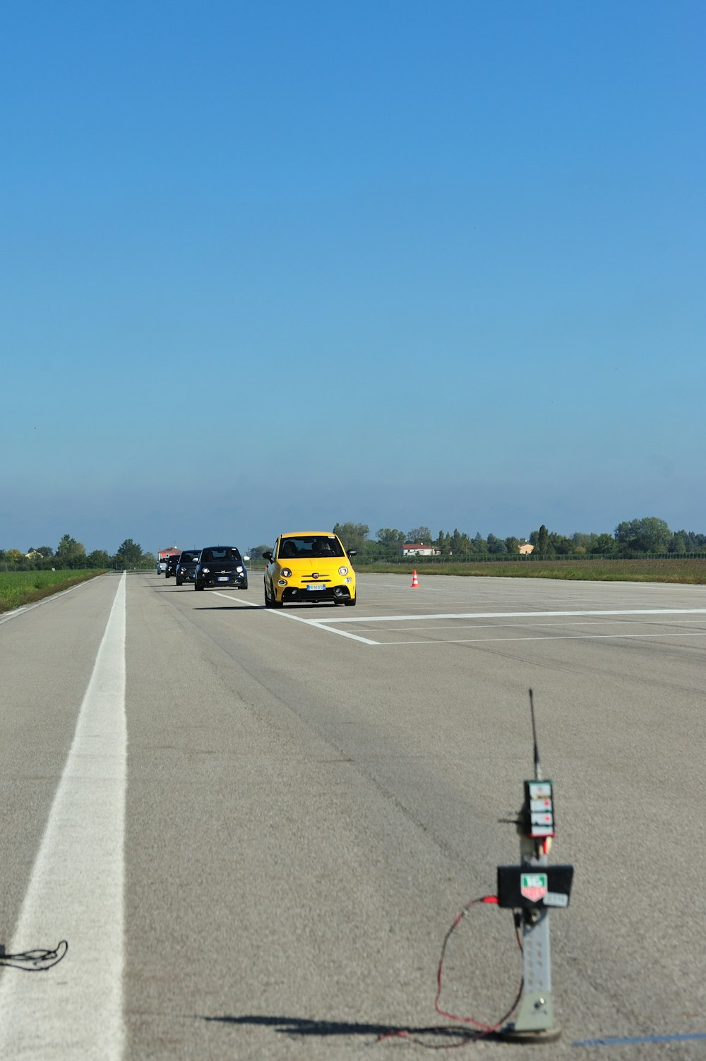 yellow FIAT 500E running on road during daytime