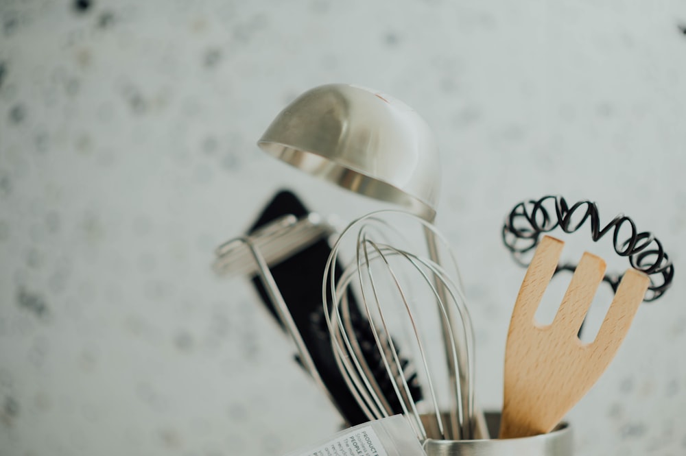 silver and brown cooking tools in selective focus photography