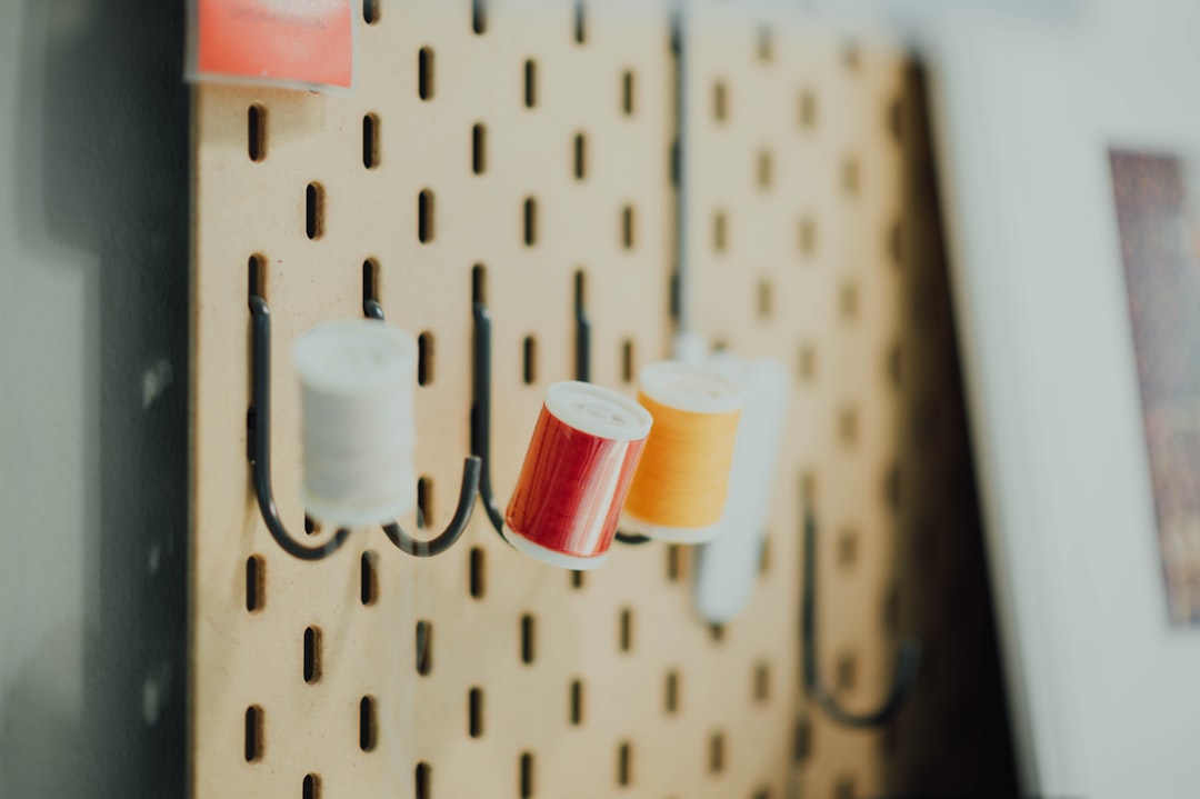 three threads hanging on wall