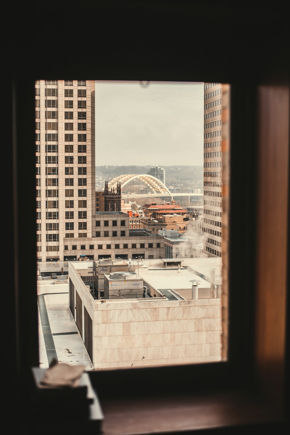 view of high-rise building rooftop from clear glass window