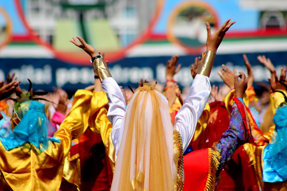 people standing while raising their hands