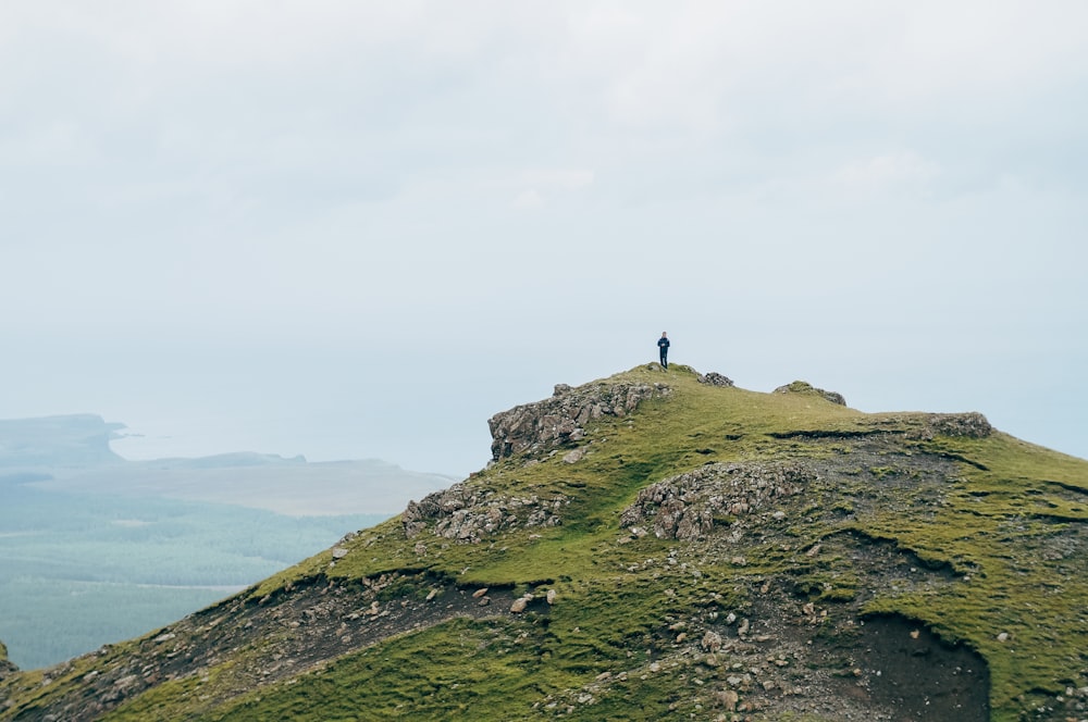 person standing on mountain during daytime