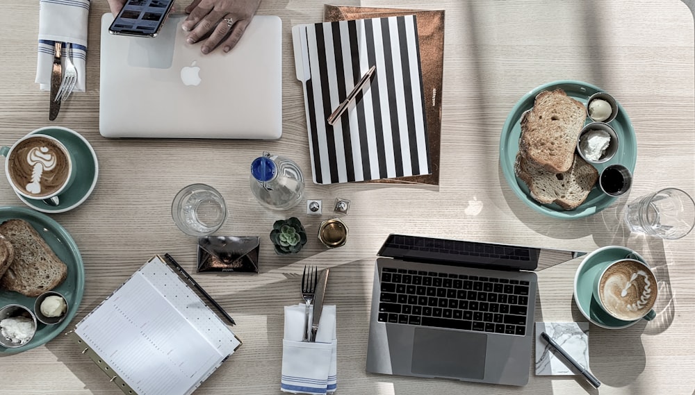 gray laptop computer near ceramic mug