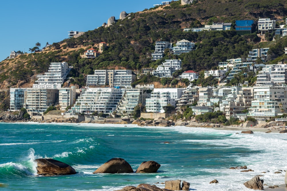 concrete buildings beside sea at daytime