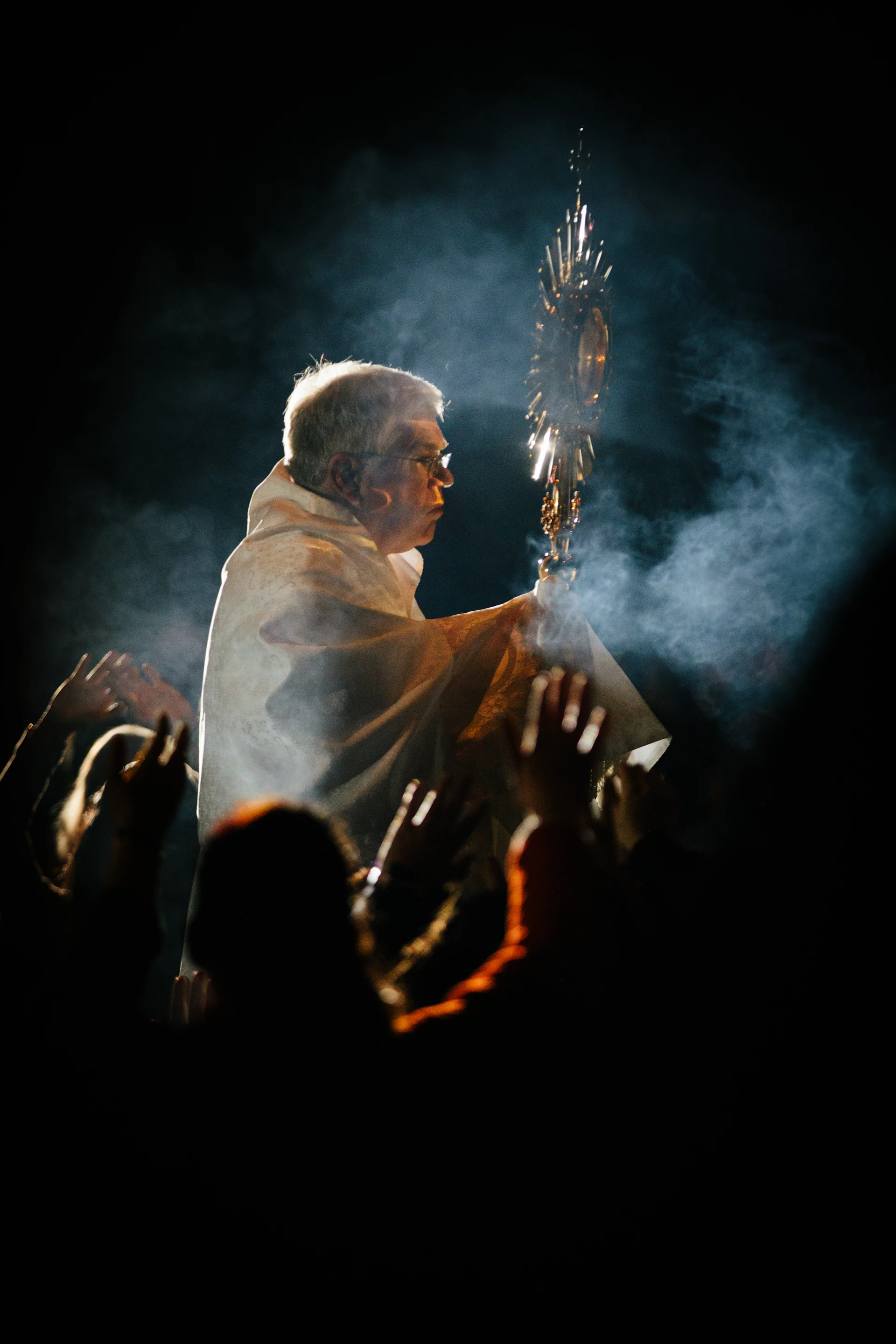 man holding stick wearing white robe