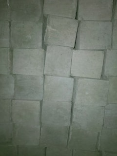 A close-up of bricks and concrete materials stacked together.
