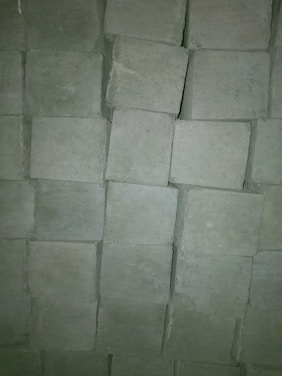Close-up of sturdy paver blocks neatly arranged outdoors.