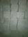 Close-up of cement bags stacked neatly at a busy construction yard.