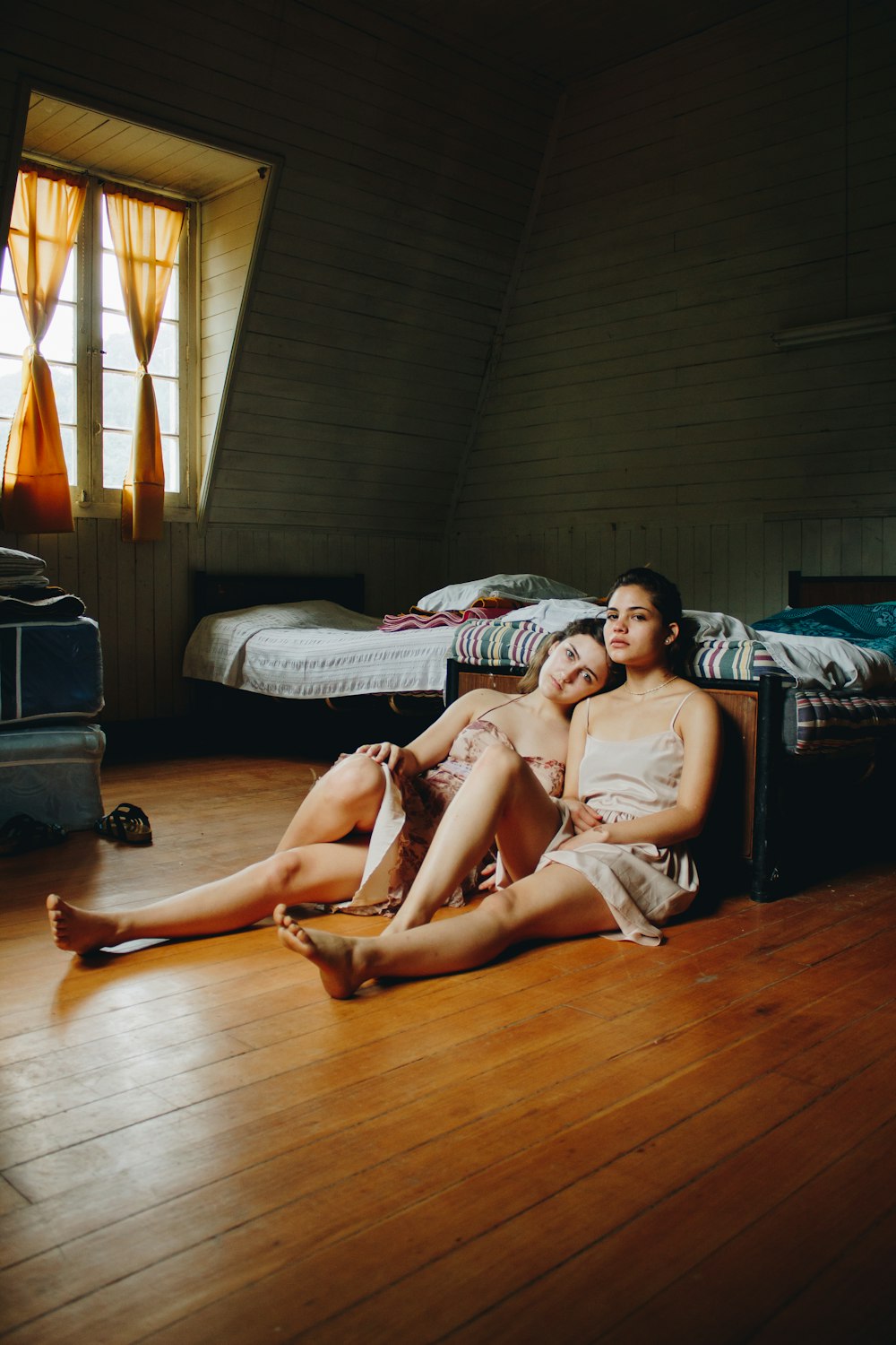 two women sitting on floor inside room