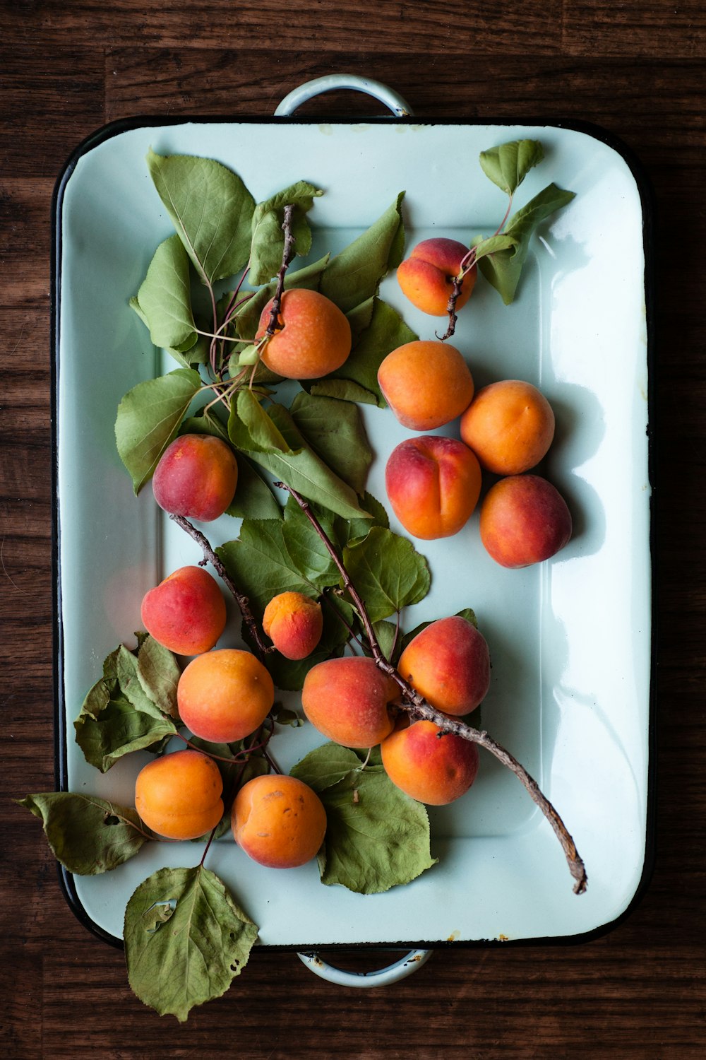 bunch of orange fruit in pl,ate