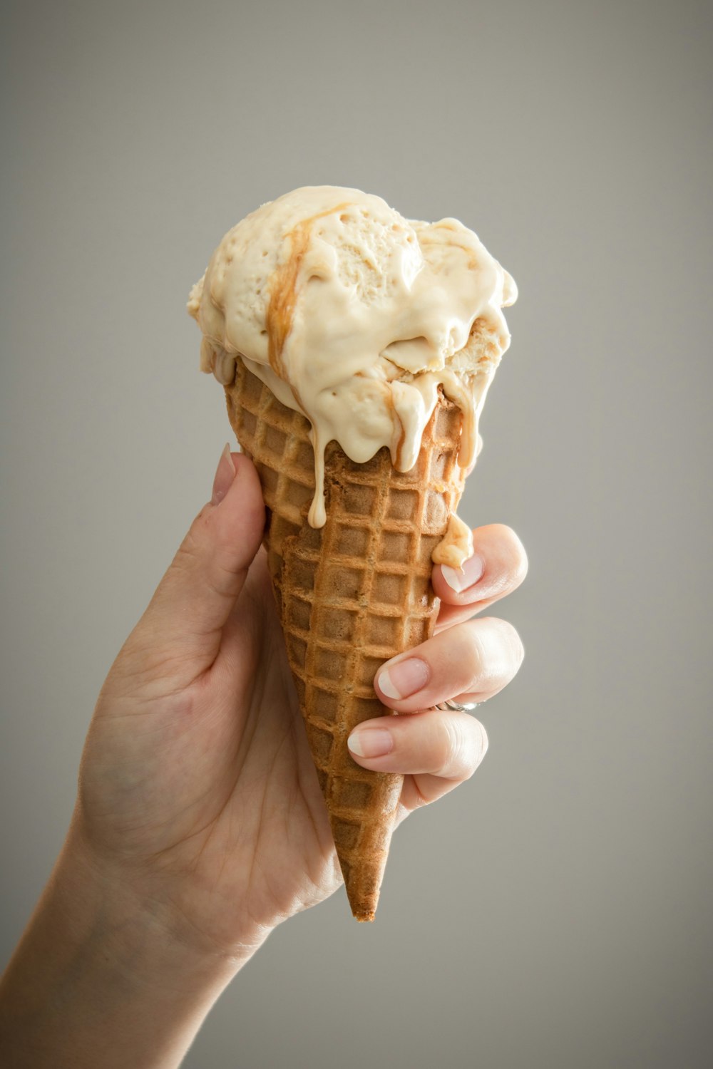 white ice cream on brown cone