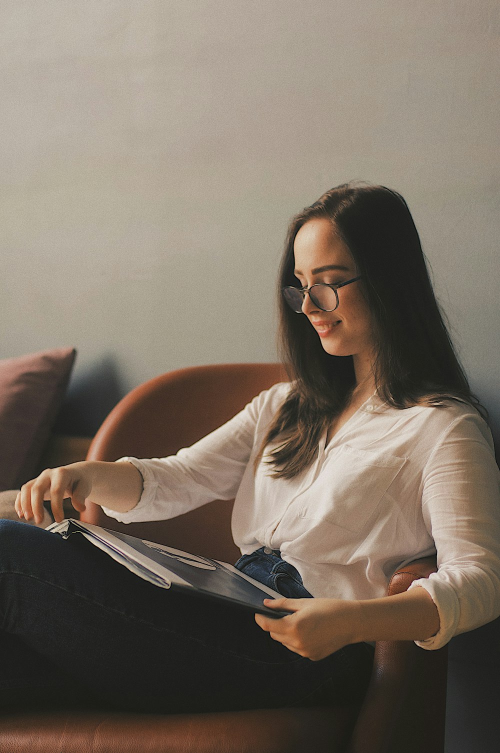 selective focus photography of woman sitting on armchair