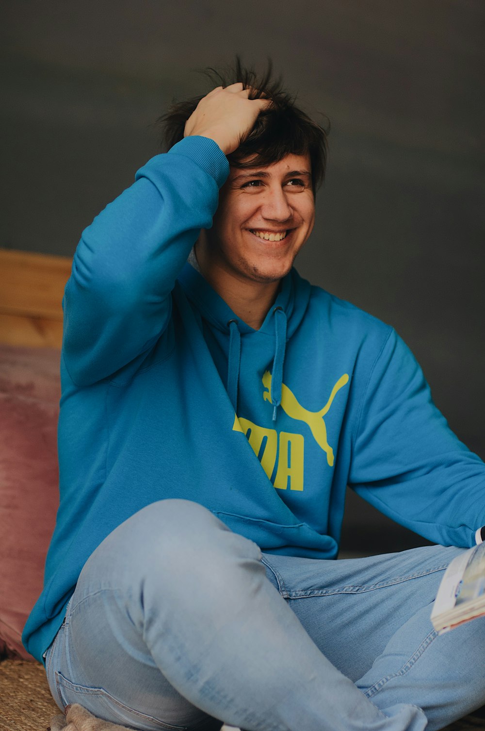 selective focus photography of man sitting on wood floor