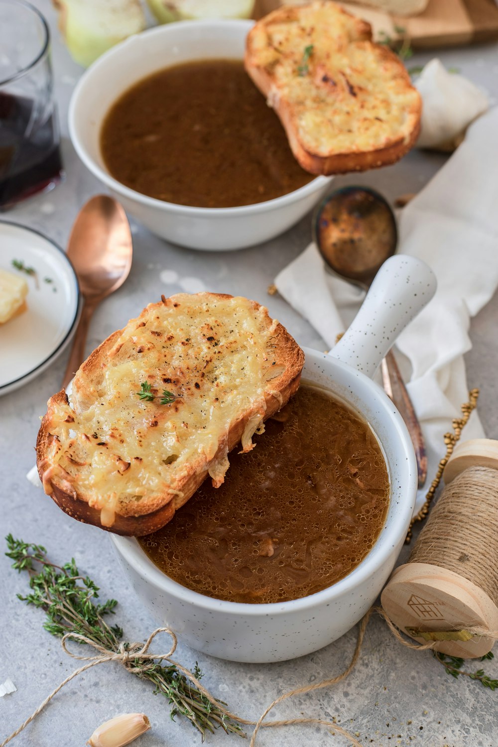 toasted breads on white ceramic bowl with brown soup