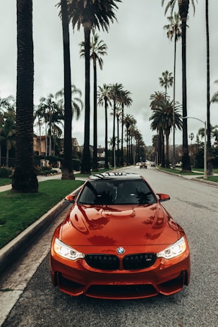 red BMW coupe parked at road
