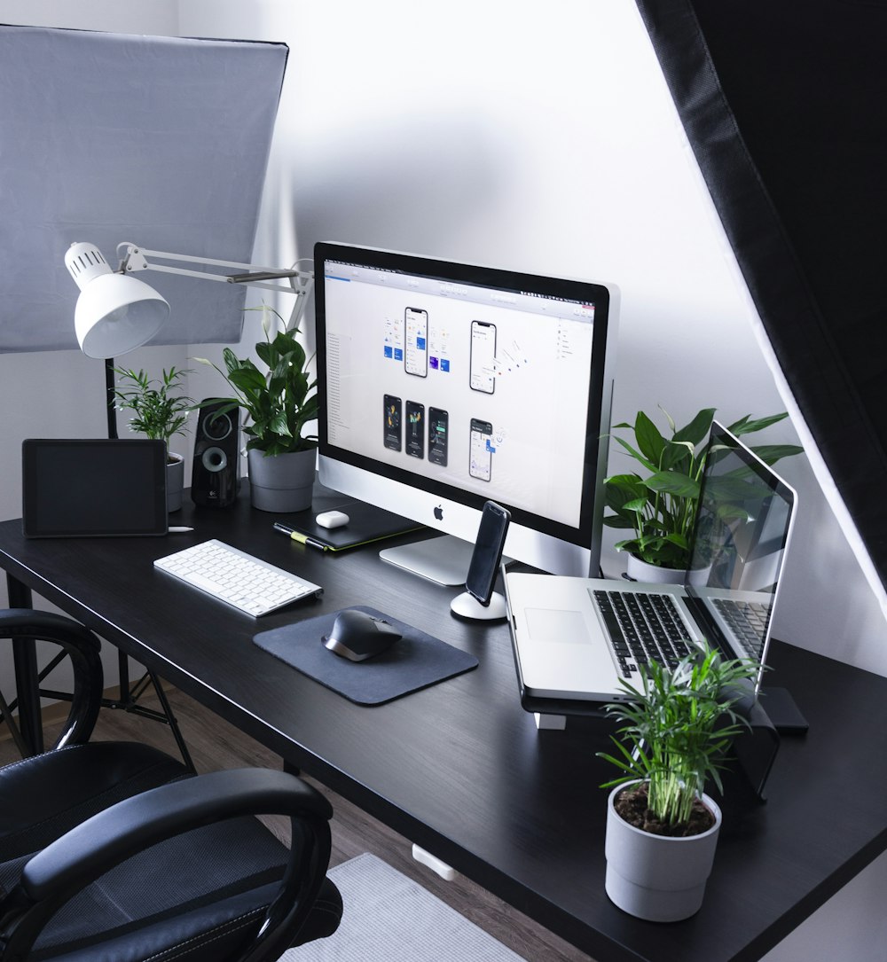 silver iMac beside MacBook Pro