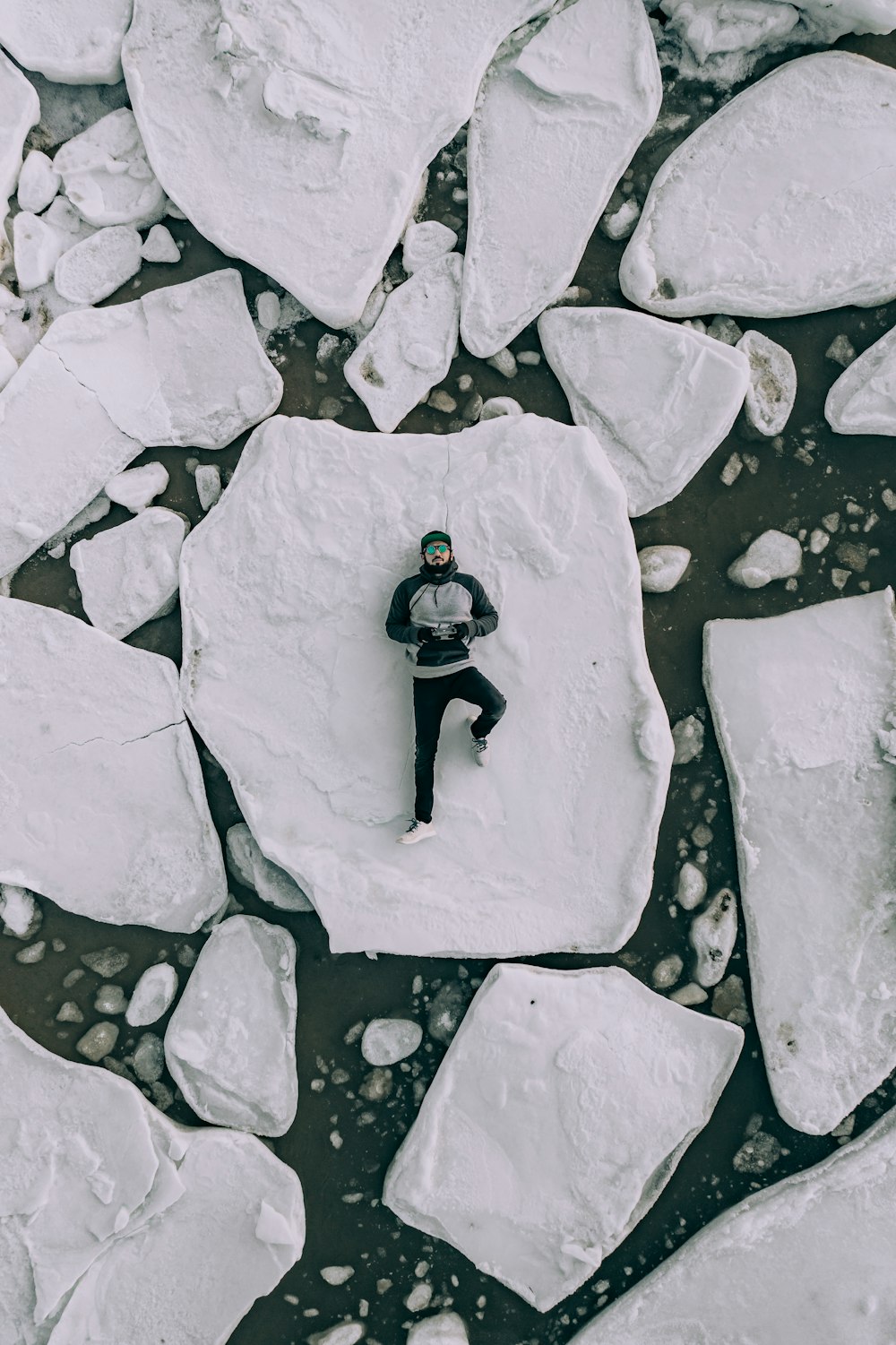 man lying on white rock during daytime