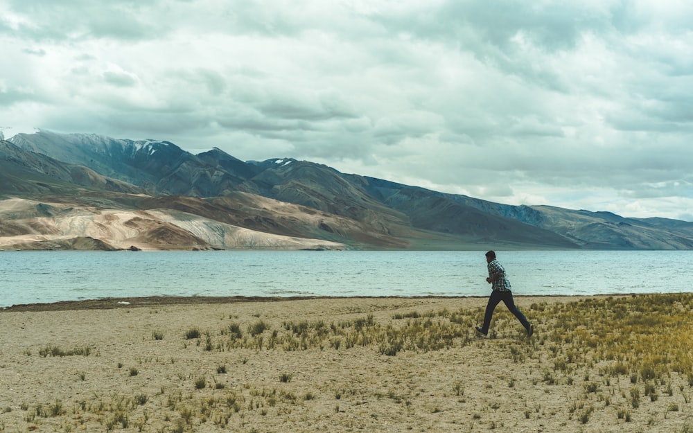 man walking near body of water