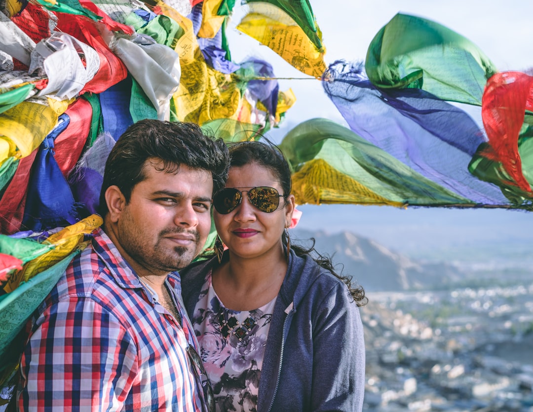 smiling man standing next to woman during daytime