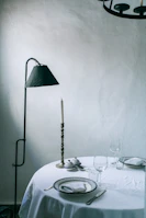 Minimalist dining table set with modern candle holders and fresh flowers